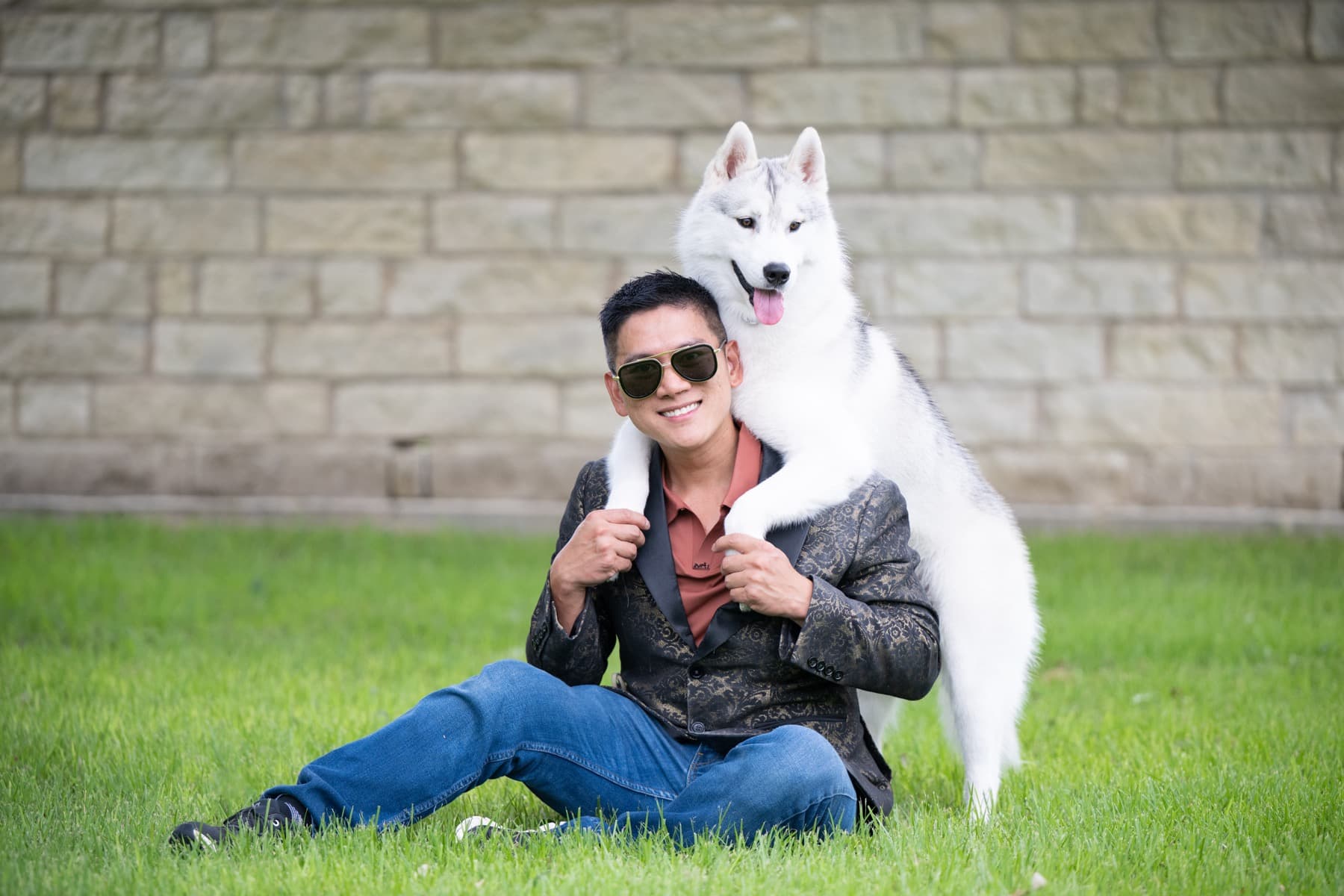Star resting his front paws on his handler's shoulders outdoors