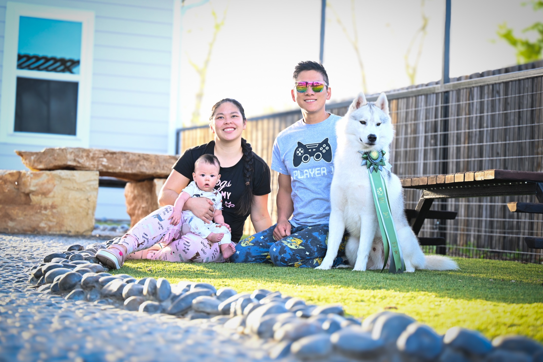 Ben, Maria, Max, and an Arkinlight Siberian Husky at home after a show win
